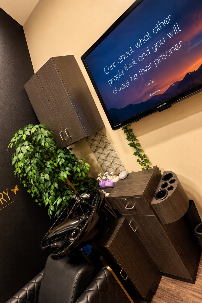 The shampoo bowl, reclining chair, and television in the Beauty Sanctuary
