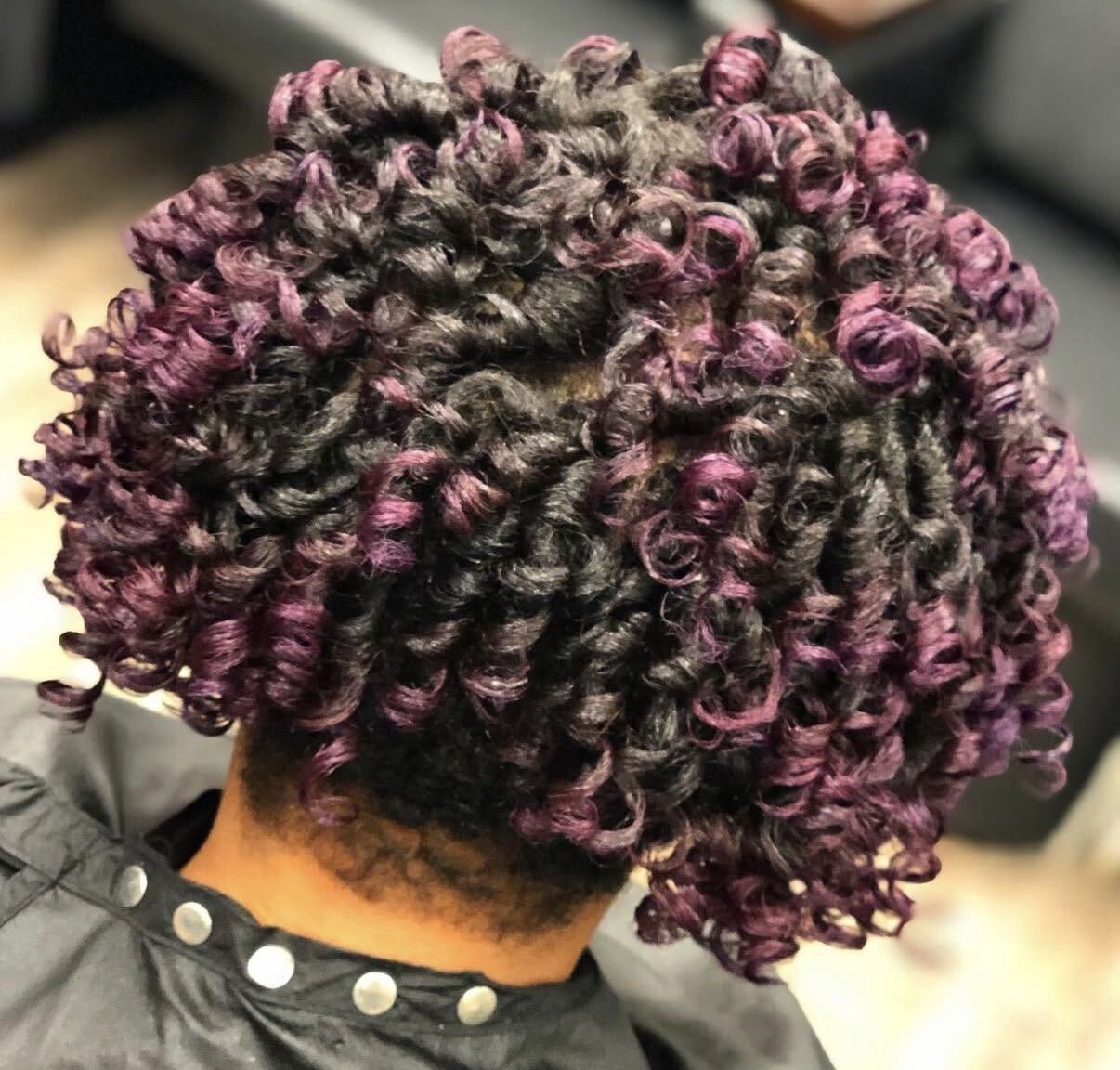 Back view of a curly rod set with purple tones by Purpose